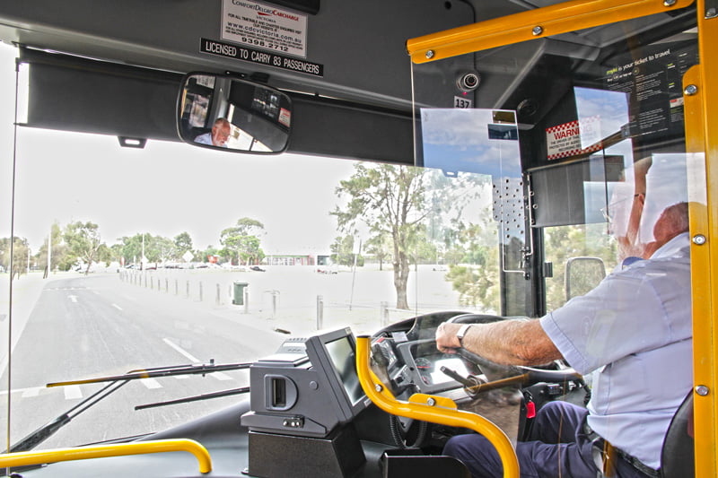 A Driver Driving A Bus With Driver Tracking Technology